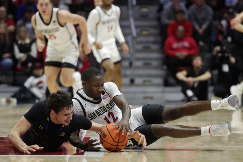 San Diego CA - February 27: San Diego State's Darrion Trammell battles San Jose State's Alvaro Cardenas for a loose ball after Trammell tipped it away at Viejas Arena on February, 2024 in San Diego, CA. (K.C. Alfred / The San Diego Union-Tribune)