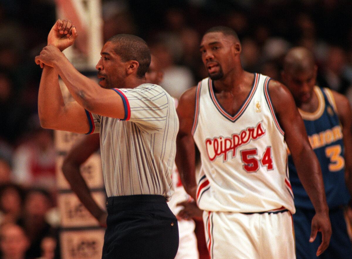 Clippers forward Rodney Rogers has a few words for referee Leon Wood after getting called for a foul.
