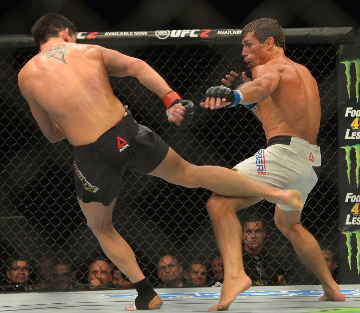 Dominick Cruz strikes with his right leg during the bantamweight title fight against Urijah Faber at UFC 199.