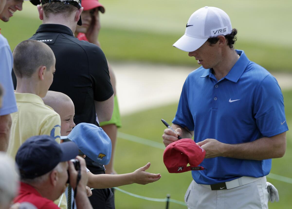 Rory McIlroy signs autographs for fans Wednesday during the pro-am for Memorial Tournament in Dublin, Ohio.