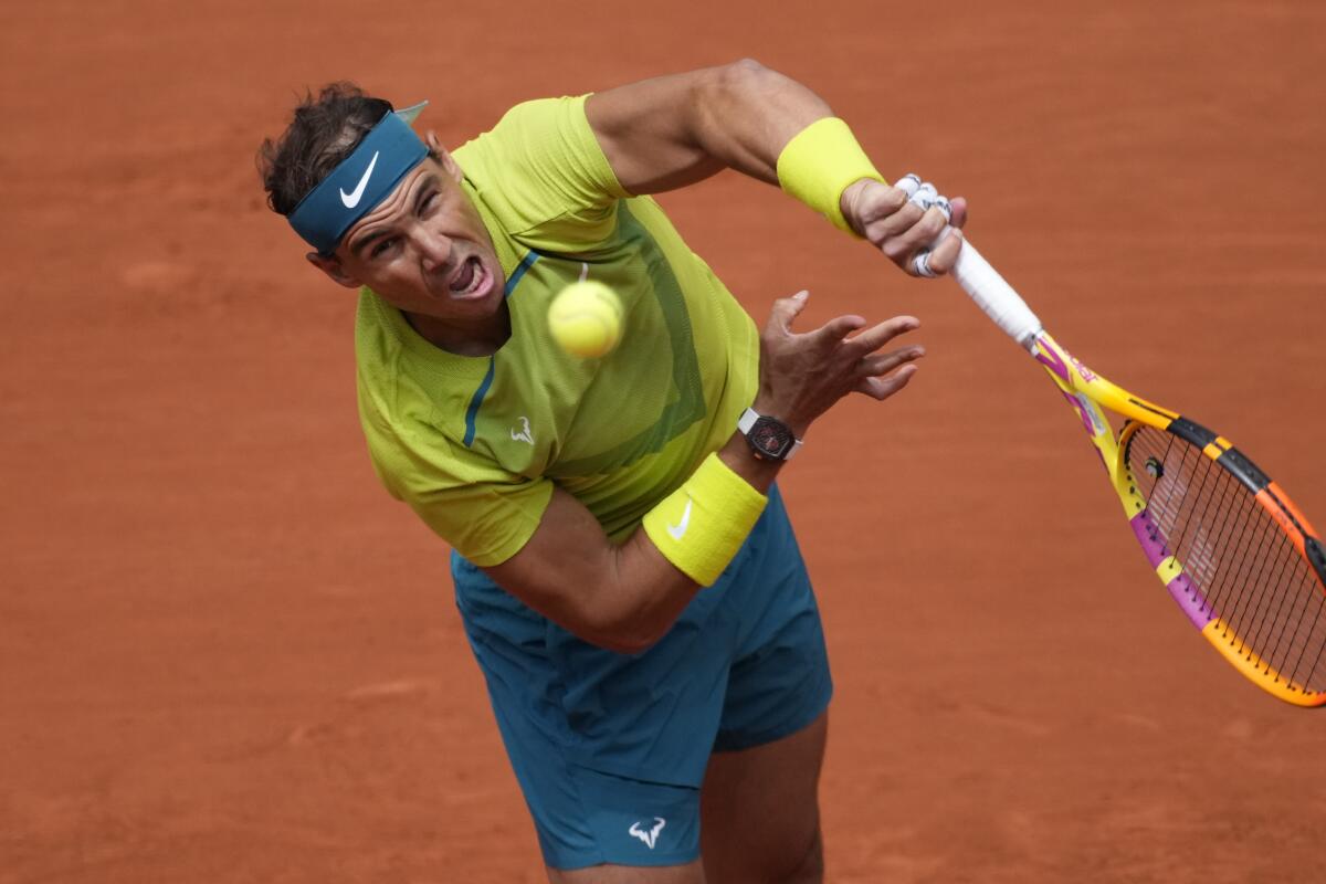 Rafael Nadal grimaces as he returns a shot.