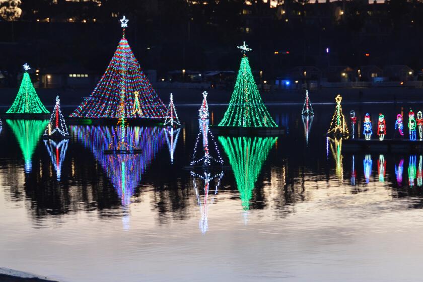 The Newport Dunes lagoon became a holiday light destination with the annual Lighting of the Bay on Friday.