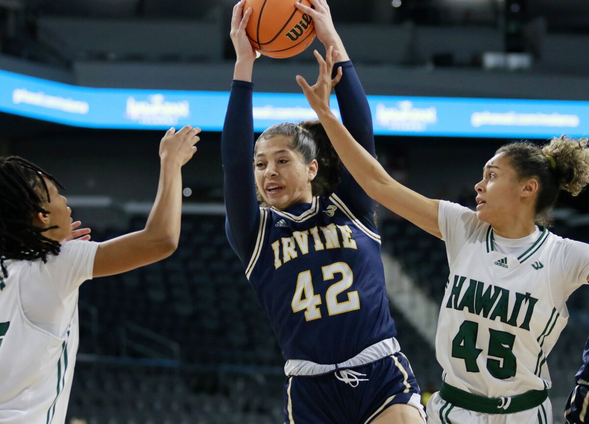 UC Irvine forward Naomi Hunt (42) goes up for a rebound around Hawaii guard Daejah Phillips, left, and Olivia Davies (45) during the first half of an NCAA college basketball game in the championship of the Big West Conference tournament, Saturday, March 12, 2022, in Henderson, Nev. (AP Photo/Ronda Churchill)