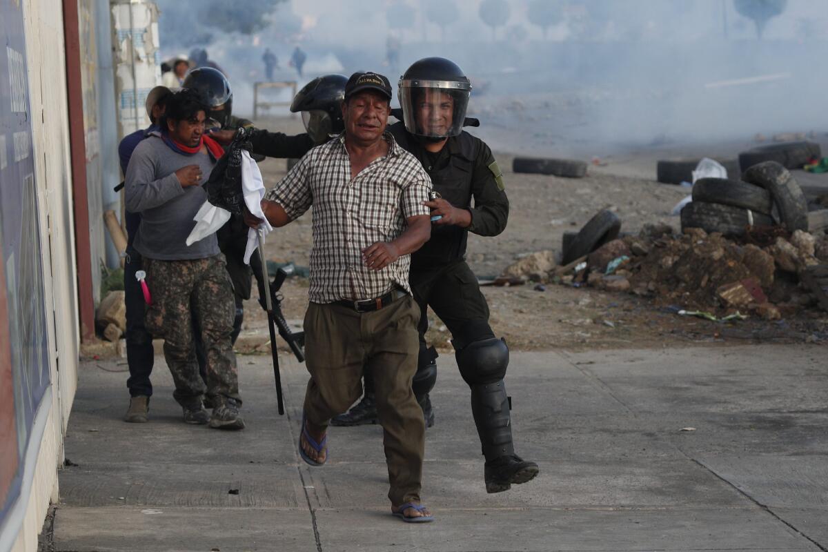 Police detain backers of former President Evo Morales on the outskirts of Cochabamba, Bolivia, on Nov. 16, 2019.