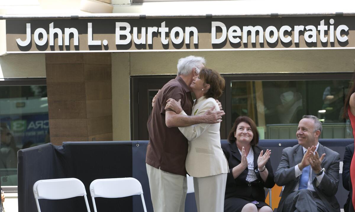 California Democratic Party Chairman John Burton embraces House Minority Leader Nancy Pelosi on Monday during the grand opening of a new Sacramento headquarters, which is named for Burton.