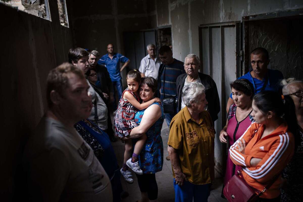 Residents of Makiyivka, near Luhansk in eastern Ukraine, take shelter in a cellar Tuesday as fighting erupted in the heart of the pro-Russia separatists' stronghold.