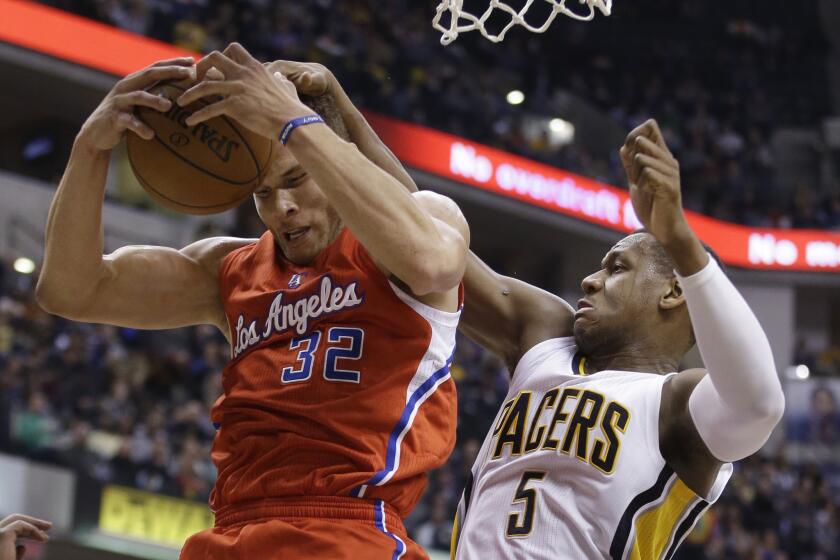 The Clippers' Blake Griffin grabs a rebound from Indiana's Lavoy Allen during a Dec. 10 in Indianapolis.