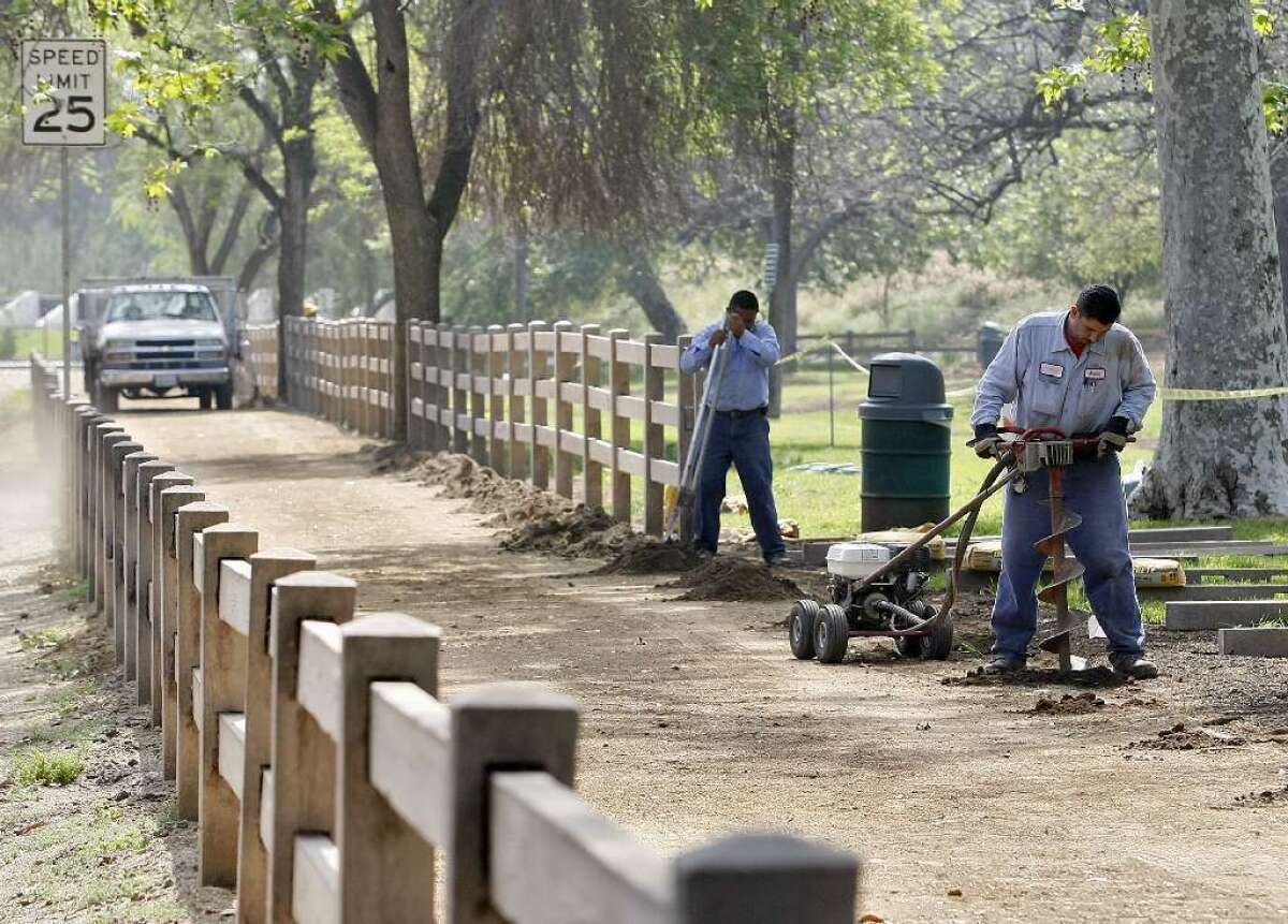 Construction workers install fence posts on a new horse and walkers trail that begins at the Glendale Narrows Riverwalk in Glendale and goes along Bette Davis Park in L.A. in March.