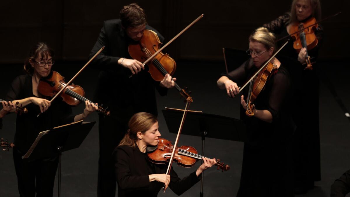 Karina Canellakis, lower center, performs both as soloist and conductor with the L.A. Chamber Orchestra in Vivaldi's violin concerto at Royce Hall on Jan. 25, 2015.