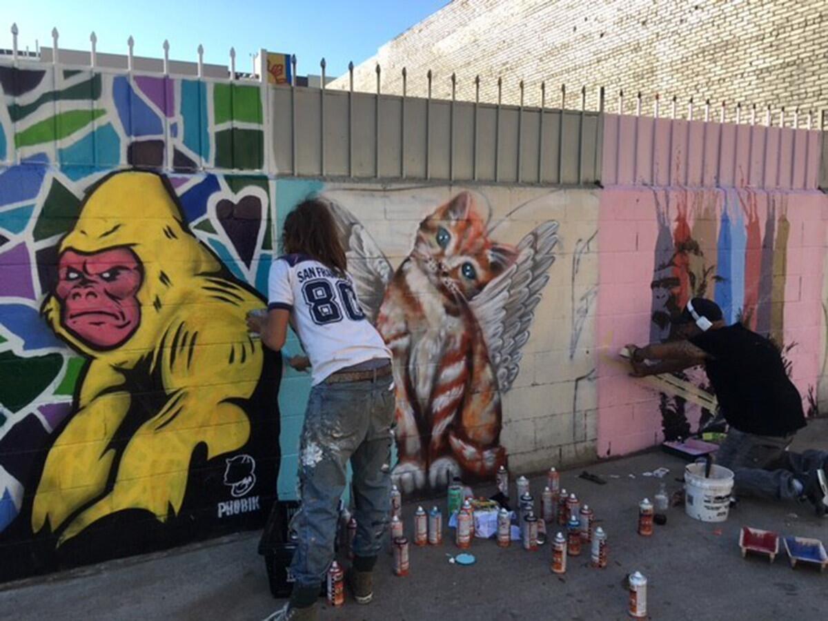 Artists Jules Muck and Moncho1929 work on new murals for "Animal Alley L.A." in Echo Park.