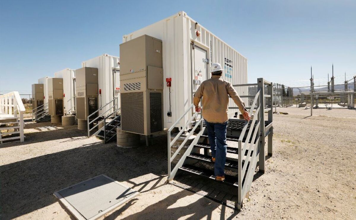 San Diego Gas & Electric engineer Steven Prsha approaches one of several shipping containers packed with lithium-ion batteries at SDG&E's Borrego Springs microgrid.