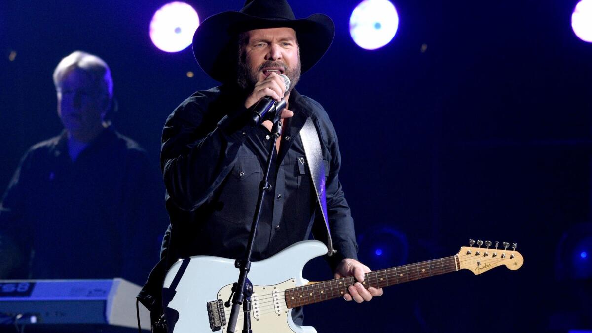 Garth Brooks, seen performing at the CMA Awards, admitted to lip-syncing.