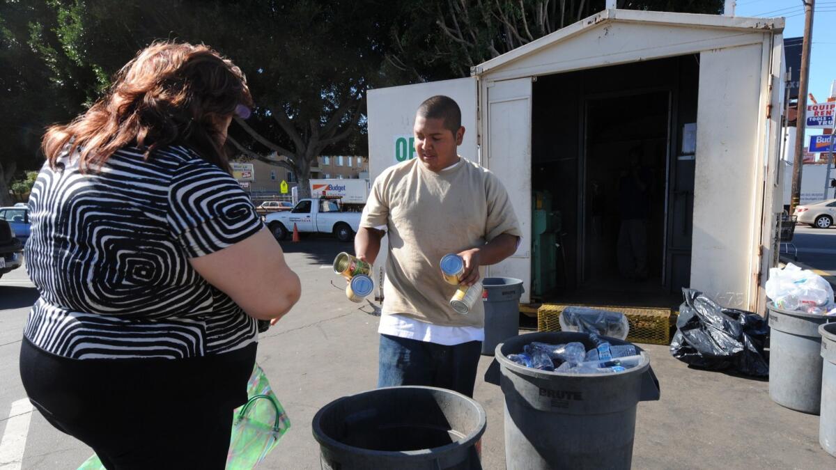 A woman makes a delivery to a recycling center in Santa Monica.