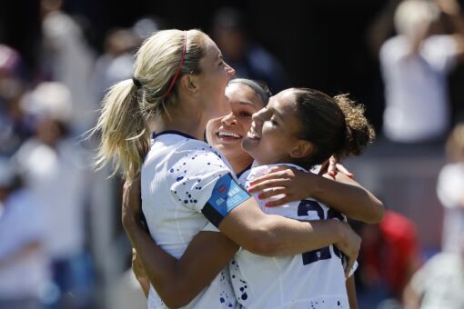United States midfielder Lindsey Horan, left, and Sophia Smith, center, celebrate.