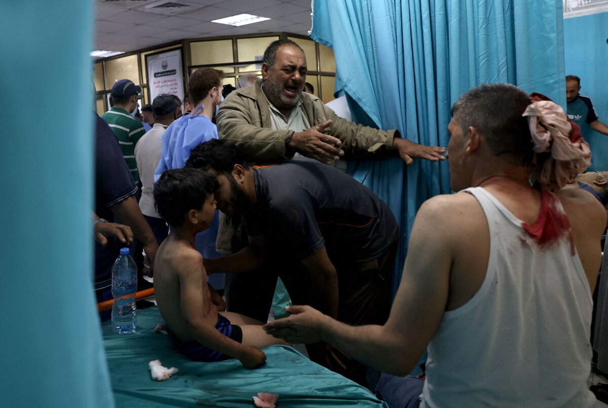 Wounded Palestinians sit at a hospital in Gaza. 