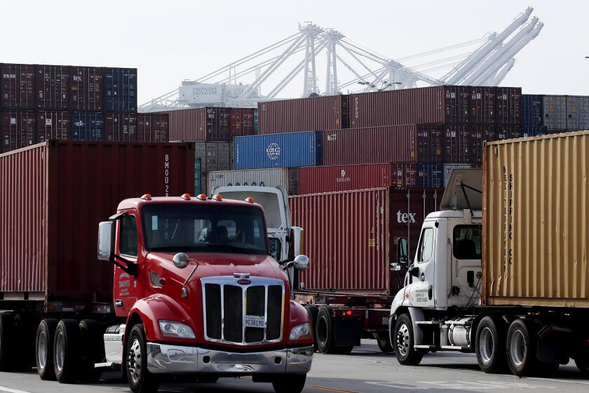 LONG BEACH, CALIF. - NOV. 18, 2021. Trucks haul cargo containers from a shipping terminal in the Port of Long Beach on Thursday, Nov. 18, 2021. (Luis Sinco / Los Angeles Times)
