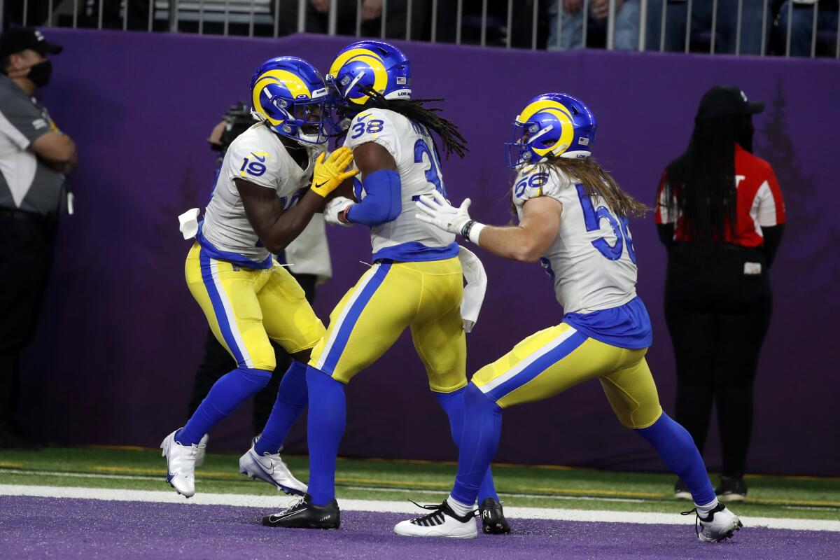 Brandon Powell celebrates with Rams teammates Buddy Howell and Christian Rozeboom after scoring on a 61-yard punt return.