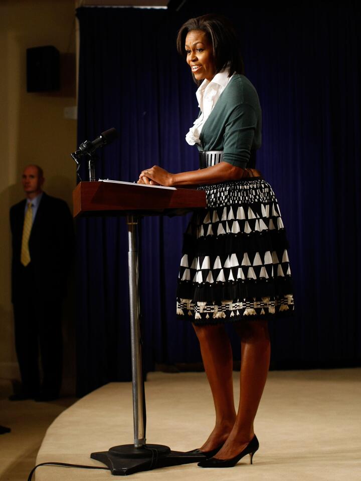 What's black and white and green over the shoulders? Obama's outfit during her speech on healthcare legislation at the White House in 2009.
