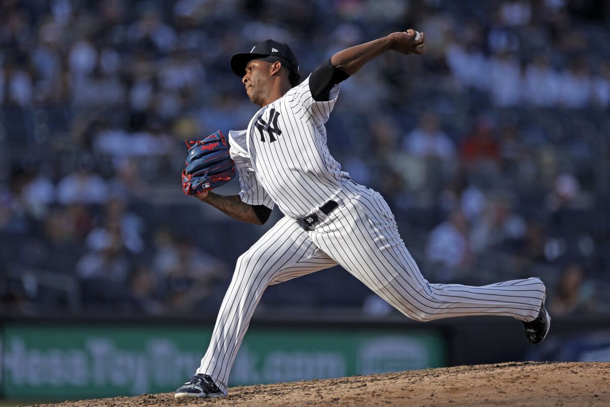 FILE - New York Yankees pitcher Joely Rodriguez pitches during the eighth inning of a baseball game against the Tampa Bay Rays on Saturday, Oct. 2, 2021, in New York. Left-hander Joely Rodríguez and the Yankees agreed to a $2 million, one-year contract Wednesday night, Nov. 10, 2021 three days after New York declined a $3 million option in favor of a $500,000 buyout.(AP Photo/Adam Hunger, File)