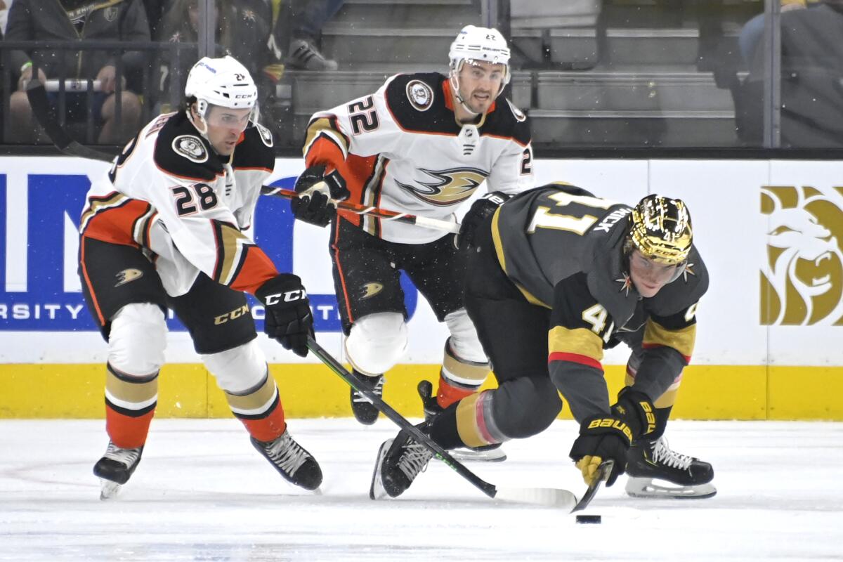 Vegas forward Nolan Patrick reaches for the puck in front of Ducks forward Vinni Lettieri and defenseman Kevin Shattenkirk.