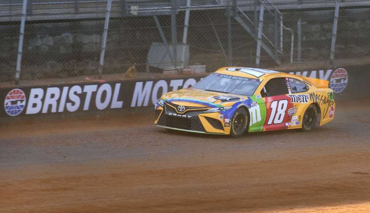 FILE - Kyle Busch drives along the dirt track during NASCAR Cup Series practice, Friday, March 26, 2021, at Bristol Motor Speedway in Bristol, Tenn. NASCAR has taken its new car to a short track, a superspeedway and a road course. Now the Next Gen races on dirt for the first time Sunday, April 17, 2022, at Bristol Motor Speedway, a beloved short track that has been covered in red Tennessee clay for a second consecutive year. (David Crigger/Bristol Herald Courier via AP, File)