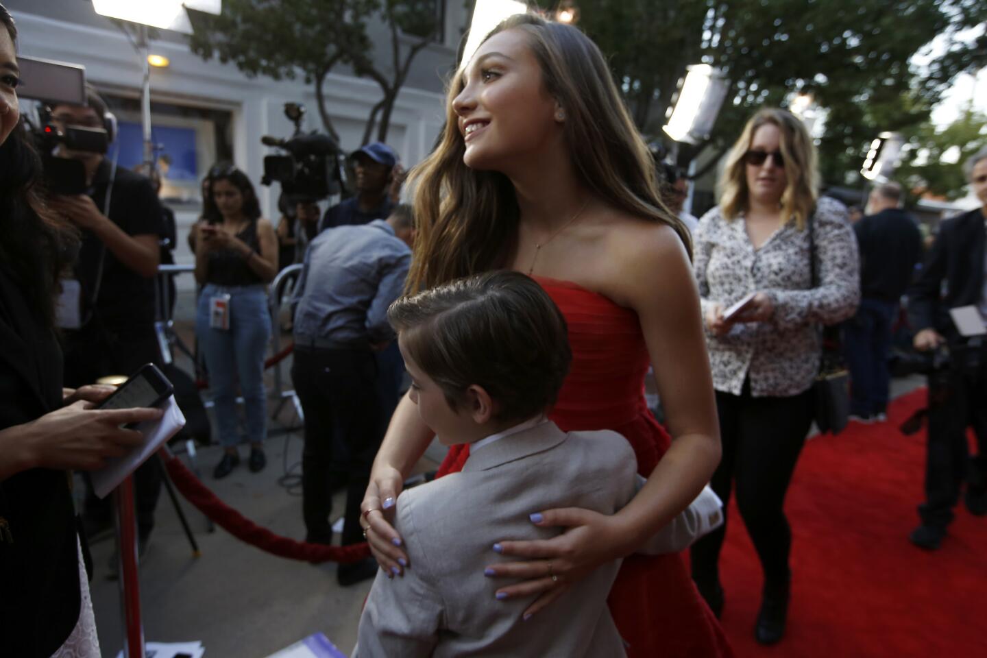 Actress Maddie Ziegler hugs actor Jacob Tremblay from the movie "The Book of Henry."