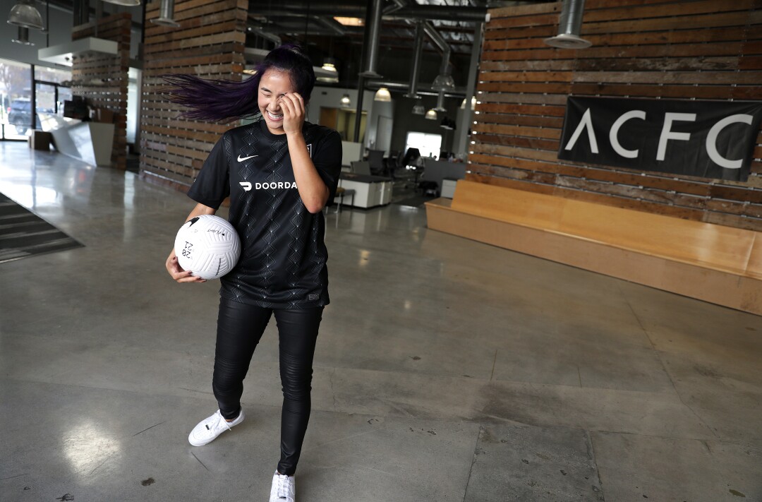 Professional soccer freestyler Caitlyn Schrepfer wears the Angel City FC inaugural home jersey during a photo shoot.