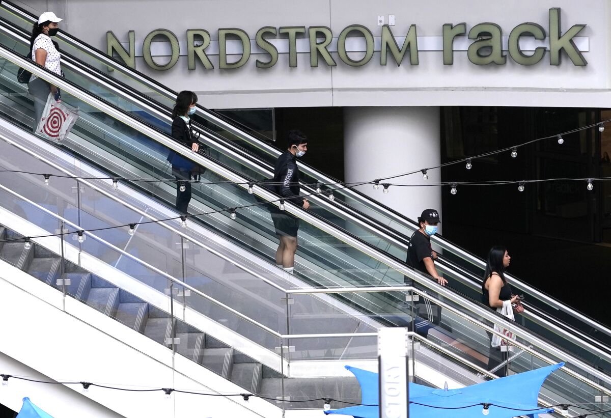 People shop near the Nordstrom Rack in downtown Los Angeles on March 15. 