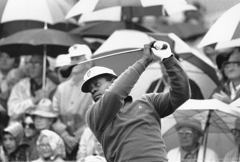 FILE - Lee Elder watches the flight of his ball as he tees off in the first round of play at the Masters in Augusta, Ga., in this April 10, 1975, file photo. Elder broke down racial barriers as the first Black golfer to play in the Masters and paved the way for Tiger Woods and others to follow. The PGA Tour confirmed Elder’s death, which was first reported by Debert Cook of African American Golfers Digest. No cause or details were immediately available, but the tour said it spoke with Elder's family. He was 87. (AP Photo/File)
