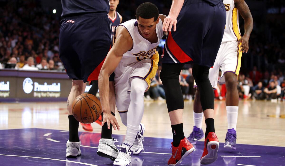 Los Angeles' Jordan Clarkson attempts to dribble between Atlanta defenders during the second half on Sunday.
