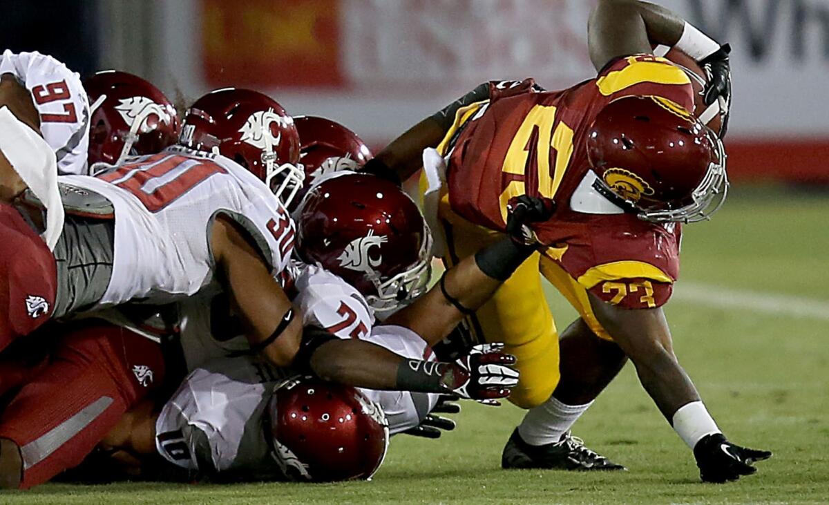 USC tailback Tre Madden is brought down by a pack of Washington State defenders Saturday at the Coliseum.