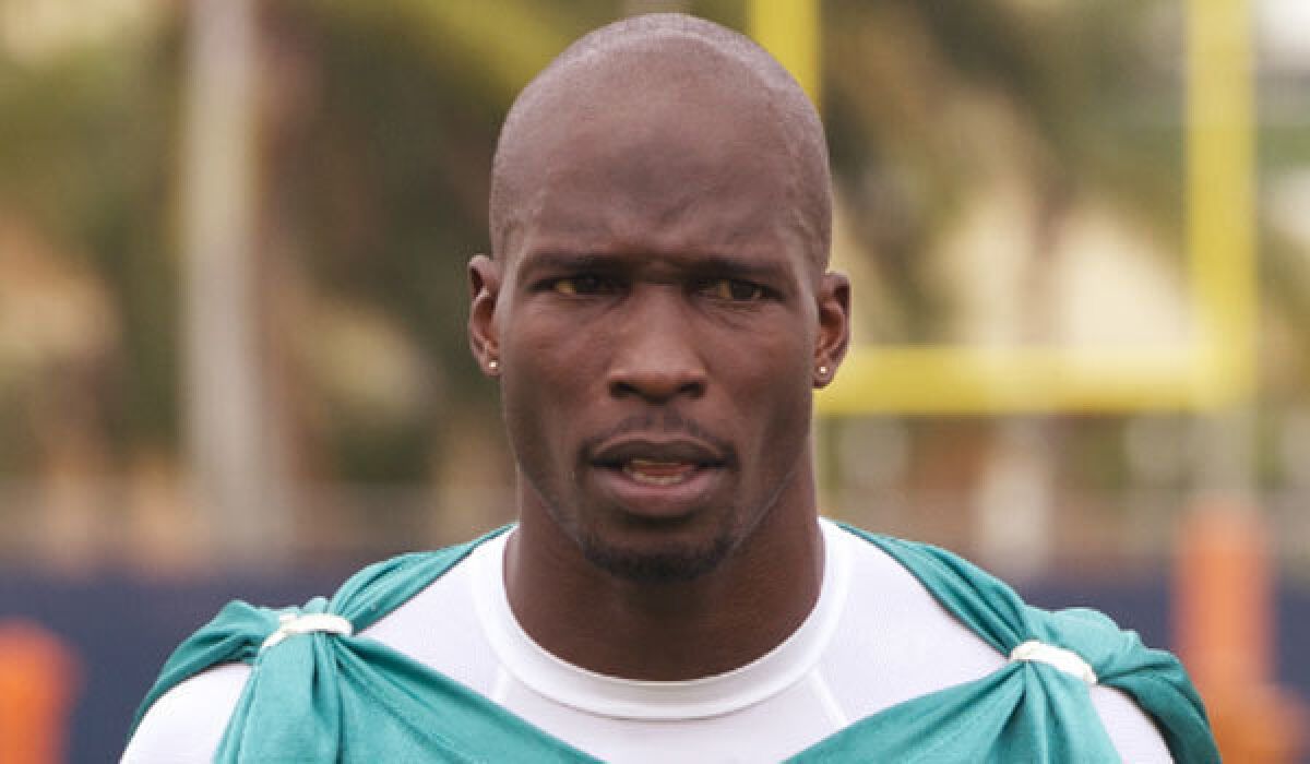 Former NFL receiver Chad Johnson, shown training with the Miami Dolphins in 2012, has been arrested for violating probation.