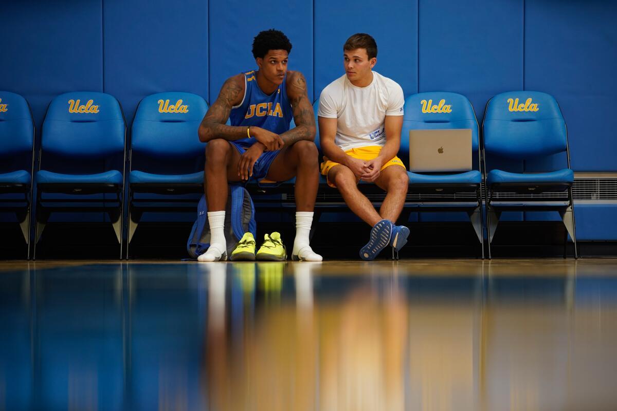 UCLA's Shareef O’Neal, left,chats on the sidelines before practice at the Mo Ostin Basketball Center on Thursday in Westwood.