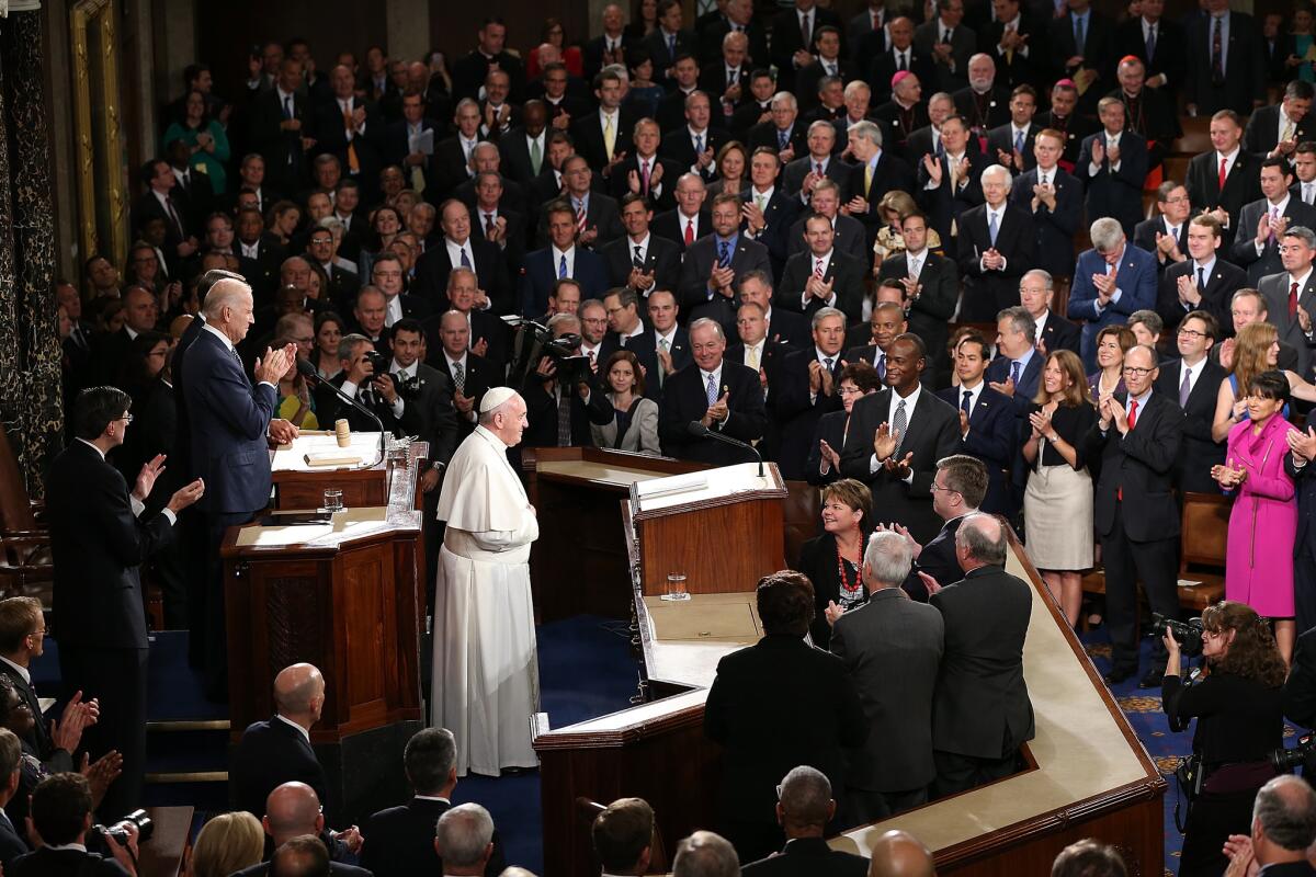 Pope Francis is applauded by members of Congress as he arrives to speak during a joint meeting of the U.S. Congress in the House Chamber of the U.S. Capitol on September 24, 2015 in Washington, DC. Pope Francis is the first pope to address a joint meeting of Congress and will finish his tour of Washington later today before traveling to New York City.