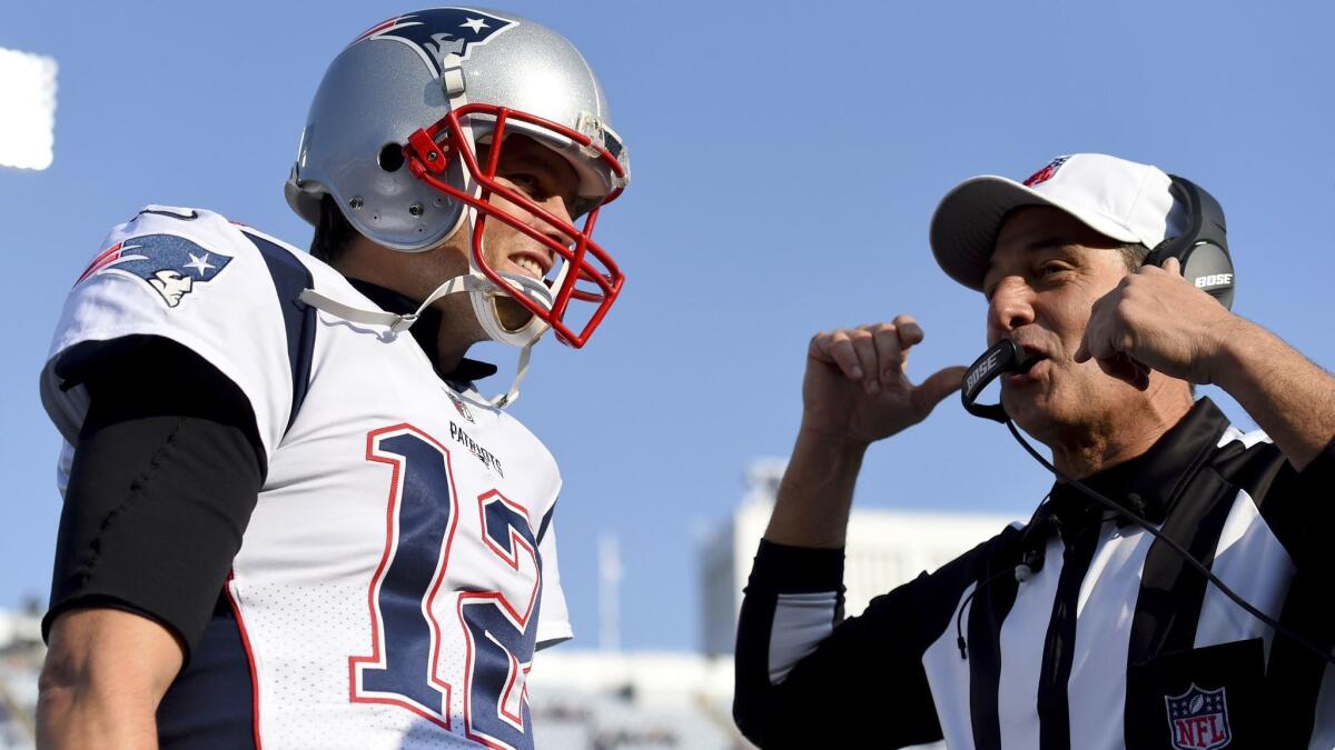 Patriots quarterback Tom Brady, left, talks to referee Gene Steratore prior to an NFL game against the Buffalo Bills in December 2017.