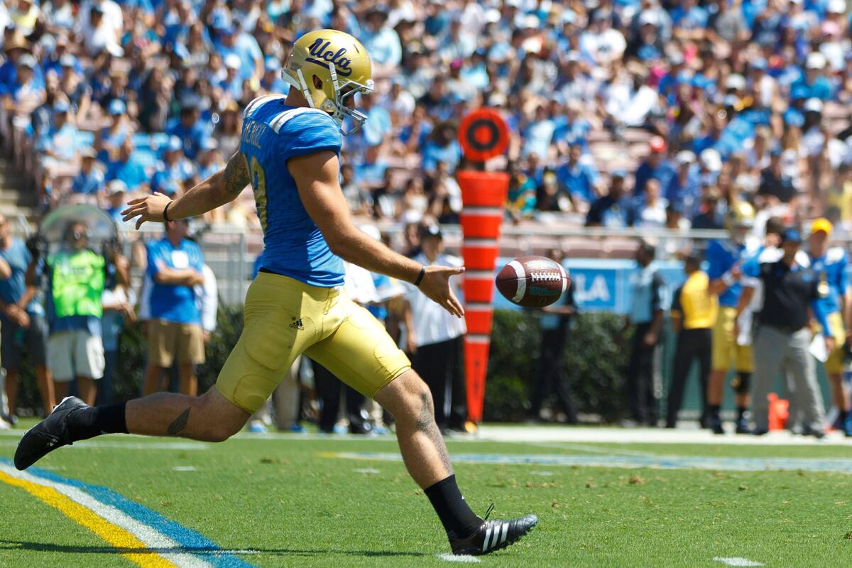 UCLA punter Matt Mengel kicks the ball away in a game against the Virginia Cavaliers in September.