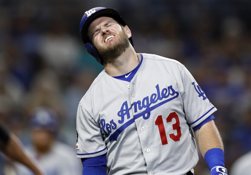 Max Muncy reacts after being hit on the arm while batting during the fifth inning of the Dodgers' loss to the San Diego Padres on Wednesday.