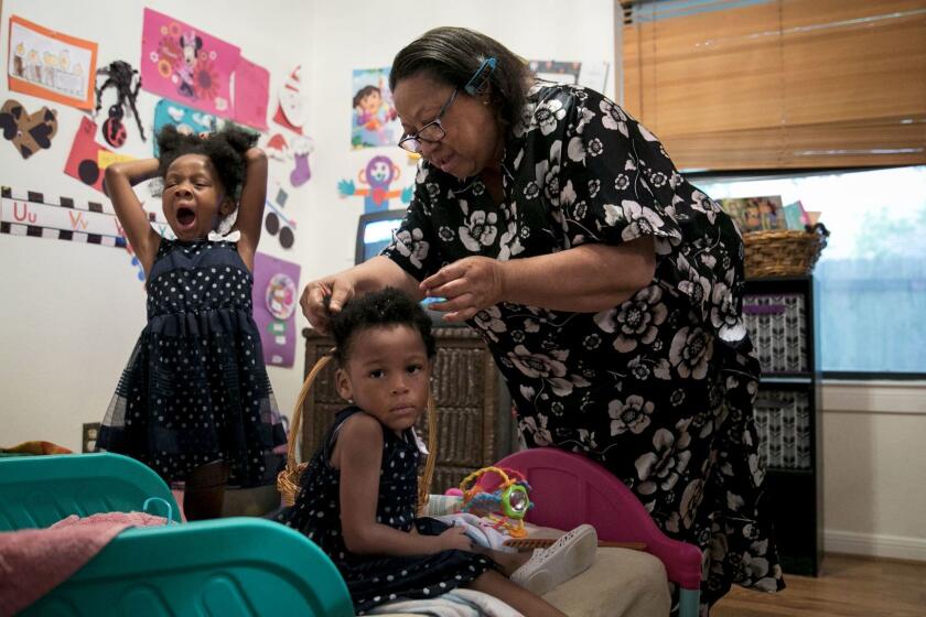 Pflugerville, Texas - July 2, 2017: Ms. Givens-Perkins brushes her granddaughters' hair for church. Cheryl Givens-Perkins cares for her three grandchildren after her daughter Cassaundra Lynn Perkins died of an infection just over a week after giving birth to her twins. She was 21. Ilana Panich-Linsman for The Los Angeles Times