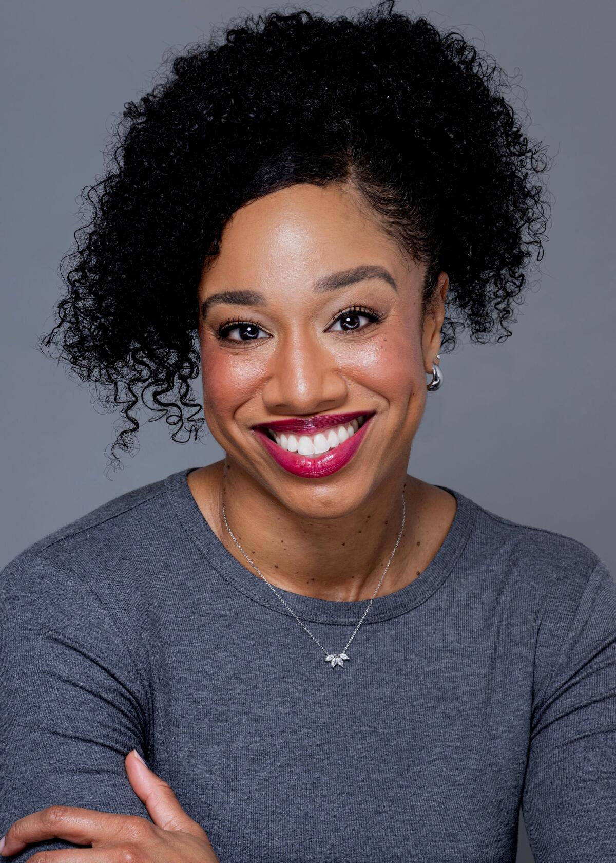 Kristen L. Berry smiles into a the camera.