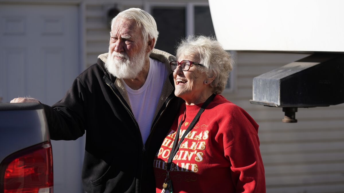 Kathy and Bud Scott pose for a photograph at their home on Dec. 3 in West Valley, Utah. 