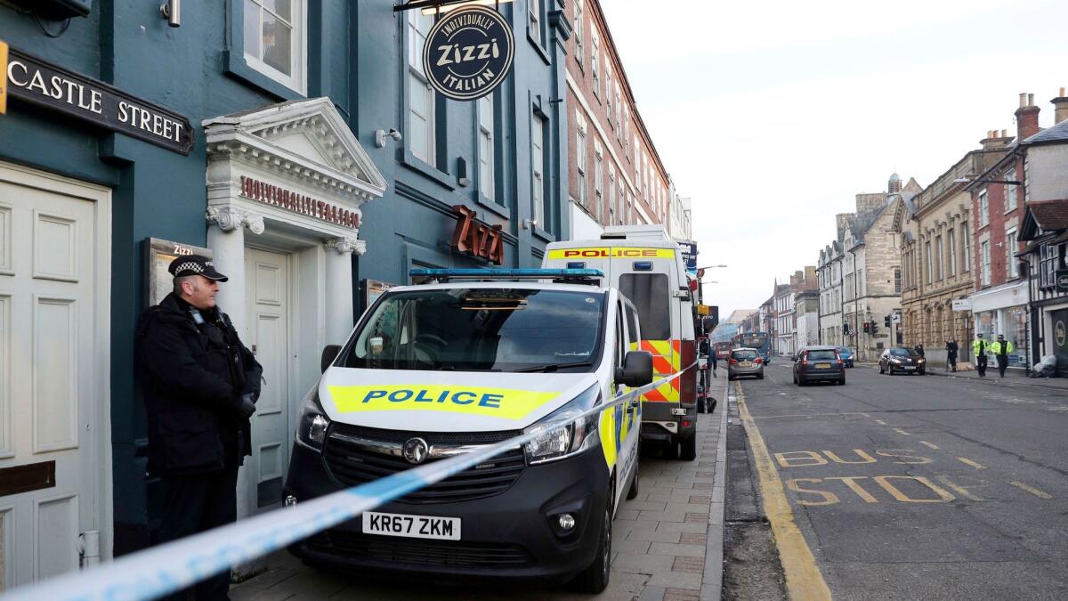 A police officer stands outside the Zizzi restaurant in Salisbury, England, on Wednesday.