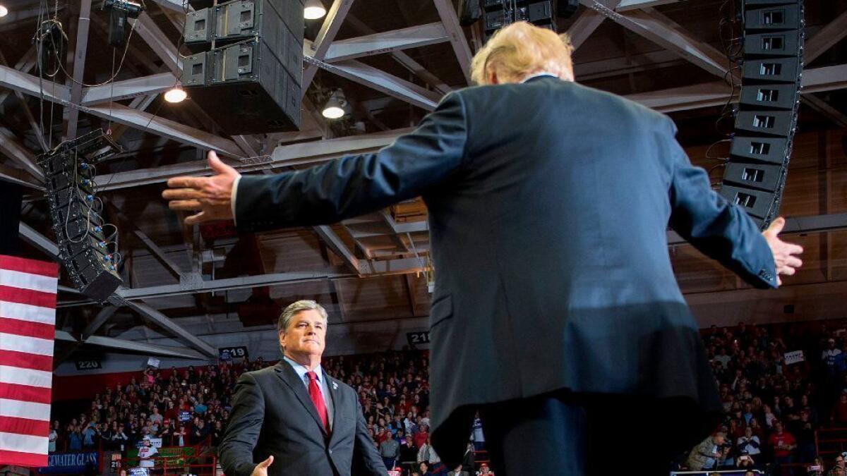 President Trump greets Fox News host Sean Hannity at a rally in Cape Girardeau, Mo., on Nov. 5, 2018.