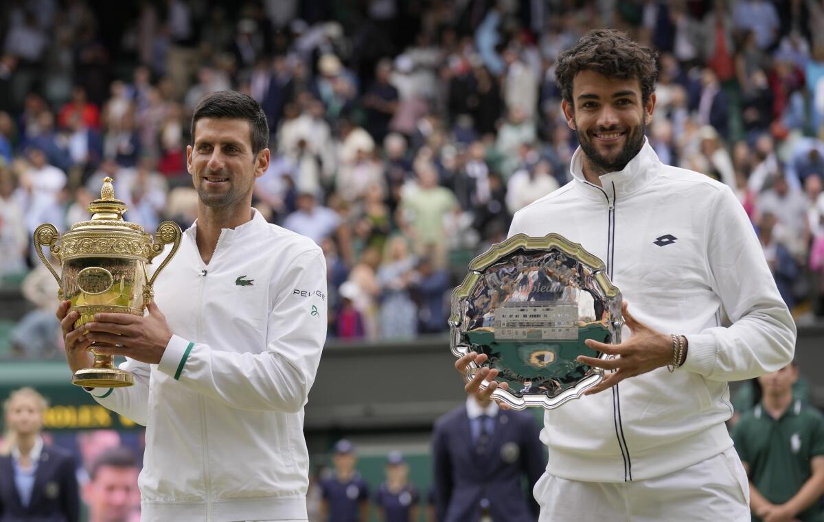 Novak Djokovic stands alongside Matteo Berrettini.