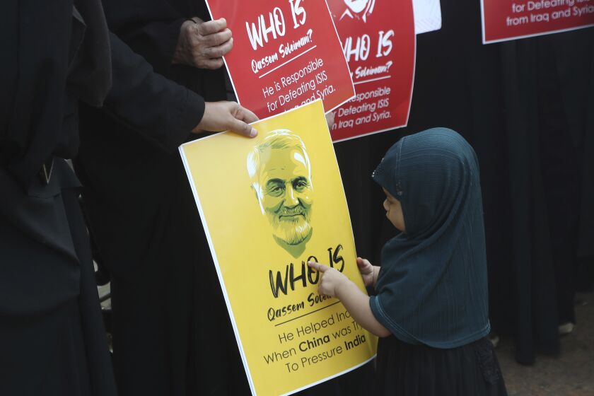 An Indian Shiite Muslim girl points at a portrait of Iranian Gen. Qassem Soleimani who was killed in a U.S. attack, during a protest against the U.S. in Mumbai, India, Thursday, Jan. 9, 2020. (AP Photo/Rafiq Maqbool)