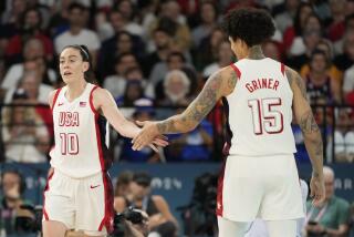 United States' Breanna Stewart (10) and Brittney Griner (15) slap hands against Australia.