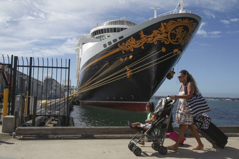Families carry their luggage as they head to the dock to board a Disney Cruise Line ship in San Diego. Disney has shown continuing interest in the Port of San Diego.