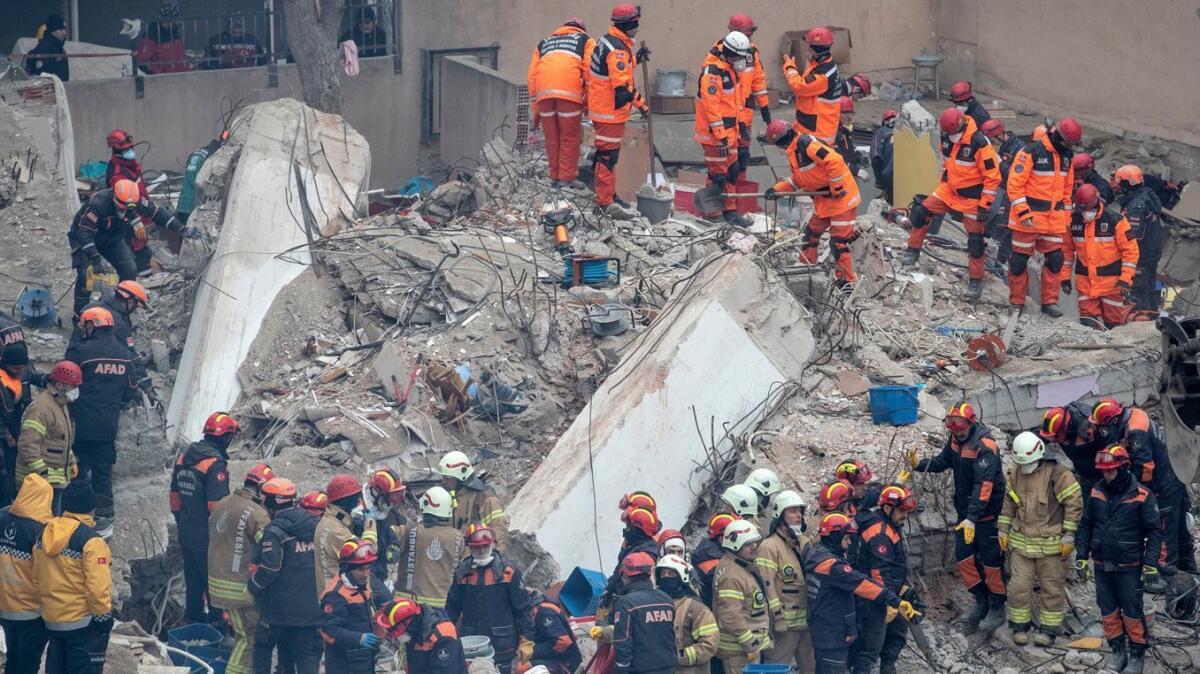 Rescuers work at the site of the collapsed building in the Kartal district of Istanbul, Turkey.