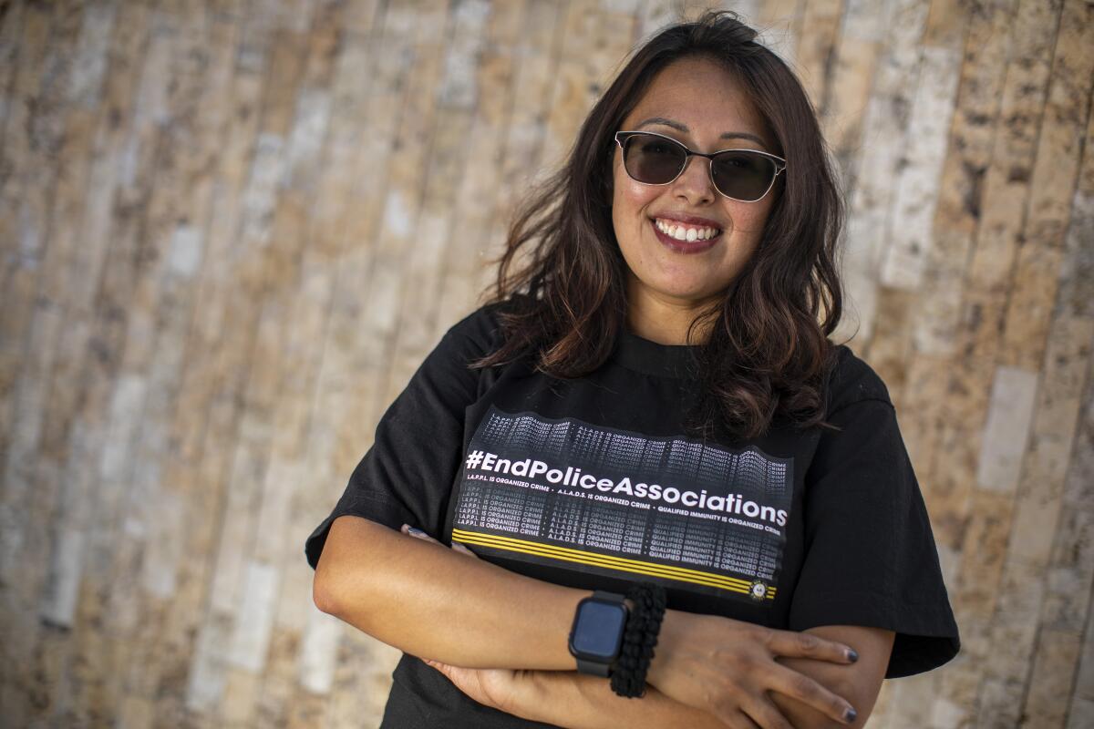 Brenda Gutierrez poses in front of a wall.