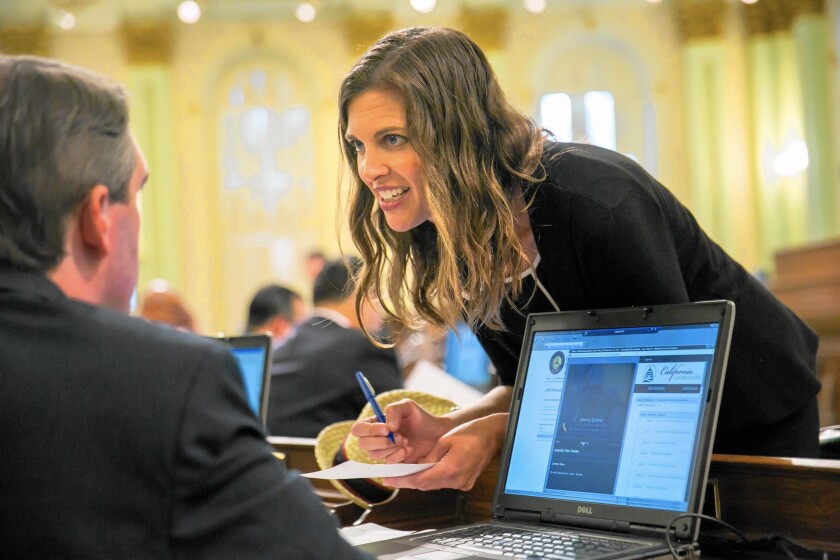 Assemblywoman Kristin Olsen confers with fellow lawmakers in Sacramento. The Modesto Republican said party officials told her that if she runs against Sen. Cathleen Galgiani (D-Stockton), she’ll be getting no help from them.