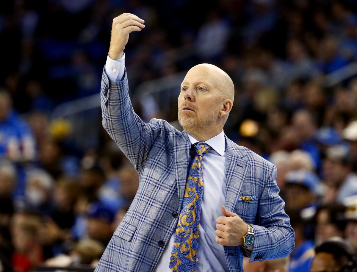 UCLA coach Mick Cronin stands on the sideline and directs his players against Arizona